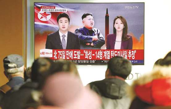 People watch a TV broadcasting a news report on North Korea firing what appeared to be an intercontinental ballistic missile (ICBM) that landed close to Japan, in Seoul.