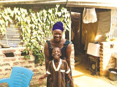 Koutu Saimon and her son Wheener stand in the courtyard of their house in Nu2019Djamena.