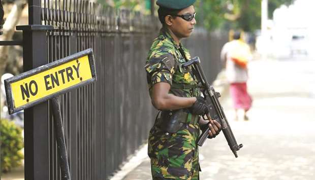 Special Task Force member stands guard at the office of newly appointed Prime Minister Mahinda Rajapakse in Colombo yesterday.