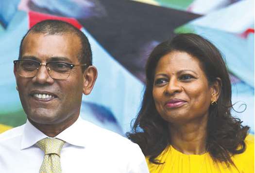 Former president Mohamed Nasheed and his wife Laila Ali leave an apartment building in Colombo yesterday.