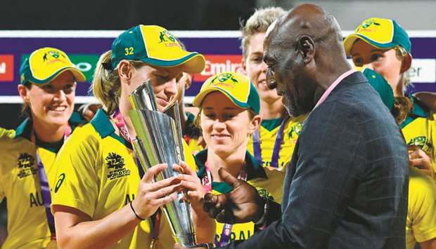 Australiau2019s Meg Lanning (left) receives the trophy from Vivian Richards after winning the ICC Womenu2019s World T20 in North Sound, Antigua, on Saturday. (AFP)