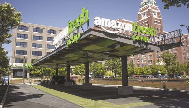 A vehicle sits at an AmazonFresh Pickup location in Seattle, Washington. The German investigation into Amazonu2019s biggest market outside the US adds to European Union scrutiny of whether the company gathers information on rival sellersu2019 successes to help launch its own products.