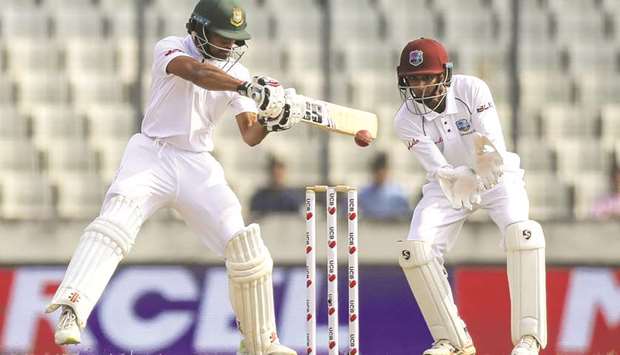 Bangladeshu2019s Shadman Islam (left) plays a shot as West Indiesu2019s wicketkeeper Shane Dowrich looks on during the first day of the second Test in Dhaka yesterday. (AFP)