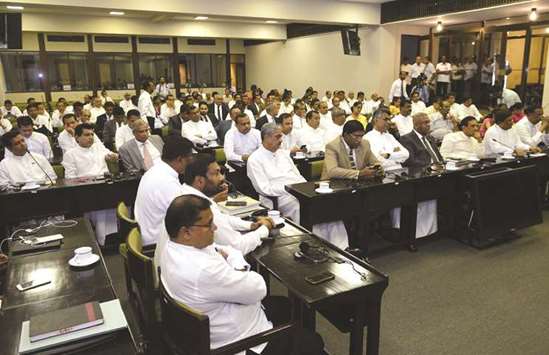 Members of parliament attend a meeting with Speaker Karu Jayasuriya at the Parliament Building in Colombo yesterday.