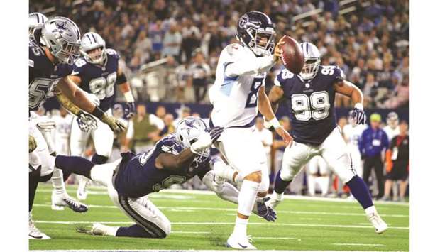 November 05, 2018:.Tennessee Titans quarterback Marcus Mariota (8)  scrambles for a first down during an NFL football game between the  Tennessee Titans and Dallas Cowboys at AT&T Stadium in Arlington, Texas.  Manny