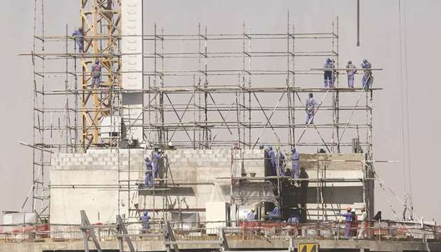 Labourers installing scaffolding at a construction site in Doha (file). Eliciting the responses of 127 construction industry professionals, a survey by Pinsent Masons found the majority of them expected an over 10% increase in workload in the next year.