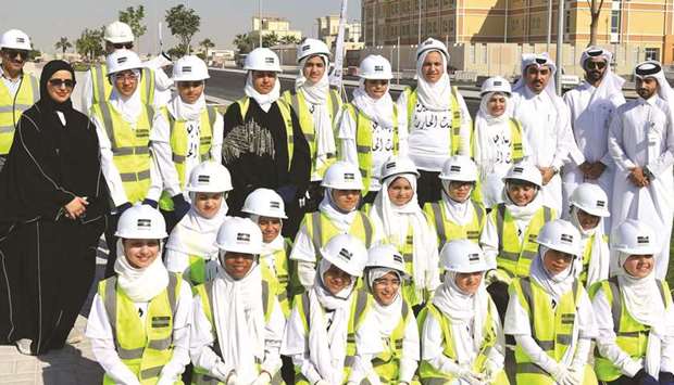 Students from Juwayriyya Bint Al Harith Primary Girls School and officials at the location of the tree planting campaign.