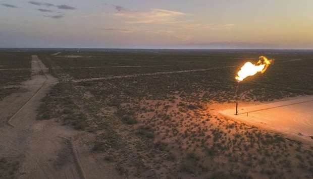 A gas flare burns at dusk in the Permian Basin in Texas, US (file). The US has emerged as the worldu2019s largest oil producer and its crude has reached more than 50 countries, with shipments often surpassing those of any Opec nation aside from Saudi Arabia.