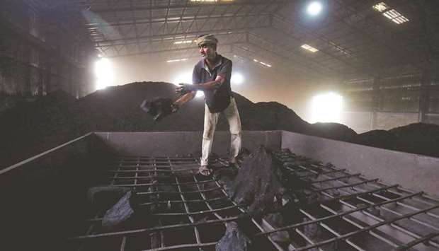 A labourer works inside a coal yard on the outskirts of Ahmedabad, India (file). The visible resistance from India on the final text of the Glasgow Climate Pact helped conceal the role played by China and even the US in the weakened outcome.