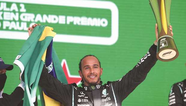 Mercedesu2019 Lewis Hamilton celebrates with trophy on the podium after winning the Brazilian Grand Prix at the Jose Carlos Pace Circuit in Sao Paulo, Brazil, yesterday. (Reuters)