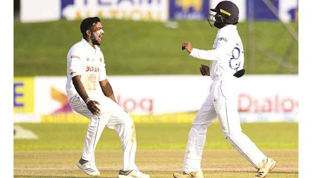 Sri Lankau2019s Ramesh Mendis (left) celebrates with teammate Oshada Fernando after dismissing West Indiesu2019 Shai Hope (not in the picture) during the second day of the first Test at the Galle International Cricket Stadium in Galle yesterday. (AFP)