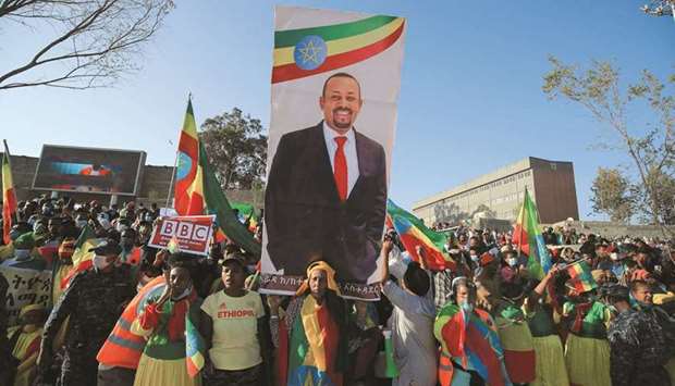 Civilians carry a placard with Prime Minister Abiy Ahmedu2019s portrait during a pro-government rally to denounce what the organisers say is the Tigray Peopleu2019s Liberation Front (TPLF) and the Western countriesu2019 interference in internal affairs of the country, at Meskel Square in Addis Ababa, yesterday.