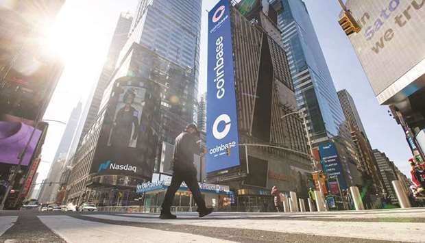 Monitors display Coinbase signage during the companyu2019s initial public offering at the Nasdaq MarketSite in New York. Coinbase is now benefiting as crypto gains more adherents, and its reach into new markets and willingness to take risks is seen by many on Wall Street as setting the stage for further growth.