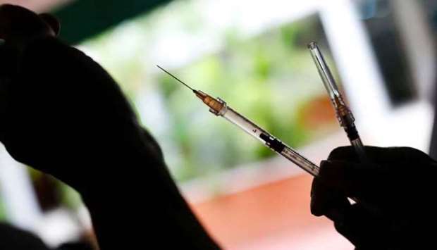 A health worker prepares a dose of the Sinopharm vaccine against the coronavirus disease.