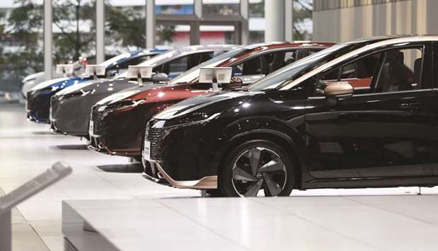 Nissan Note Aura vehicles on display in a showroom at the companyu2019s global headquarters in Yokohama, Japan. The company now projects u00a5180bn ($1.6bn) in net profit for the year to March 2022, up from an earlier estimate of u00a560bn.