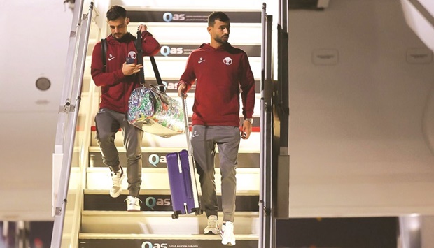 Qatar defenders Bassam al-Rawi (left) and Boualem Khoukhi arrive in Doha.