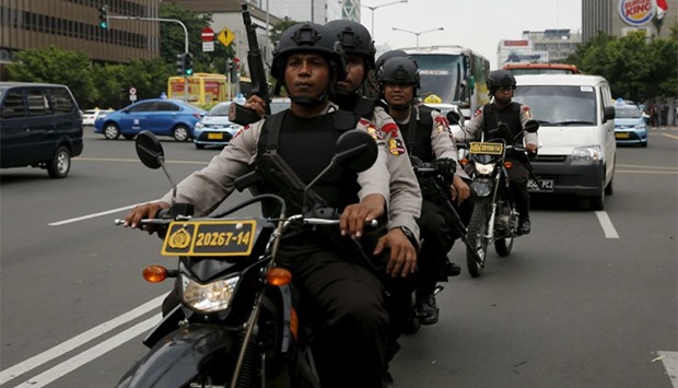 Indonesian policemen ride motorcycles as they patrol near the bomb blast site at Thamrin business district in Jakarta. Reuters