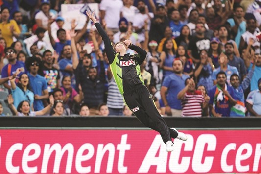 Australiau2019s Steven Smith attempts a catch during a T20 match.