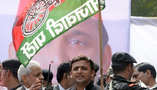 This file photograph taken on February 23, 2014,shows India's Uttar Pradesh state Chief Minister Akhilesh Yadav holding a flag bearing his Samajwadi Party symbol as he flags off a bicycle rally in New Delhi