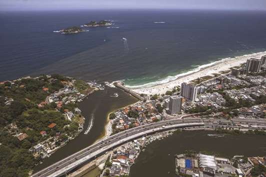 The entrance to Barra da Tijuca beach is seen in this aerial photograph taken above the Barra da Tijuca area of Rio de Janeiro (file). S&P on Thursday cut Brazilu2019s debt rating to BB-, citing delays to the approval of austerity measures aimed at taming debt levels.