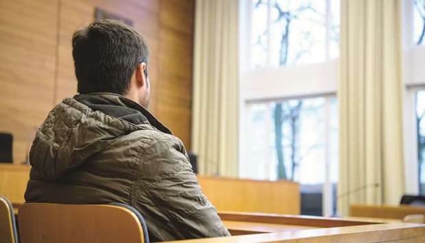 The defendant, an Afghan asylum-seeker, waits at a courtroom before his trial at a district court in Traunstein, southern Germany.