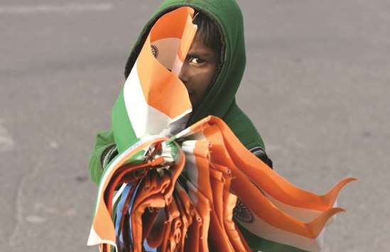 A vendor waits for customers along a road to sell Indian flags ahead of Indiau2019s 69th Republic Day celebrations in New Delhi yesterday.