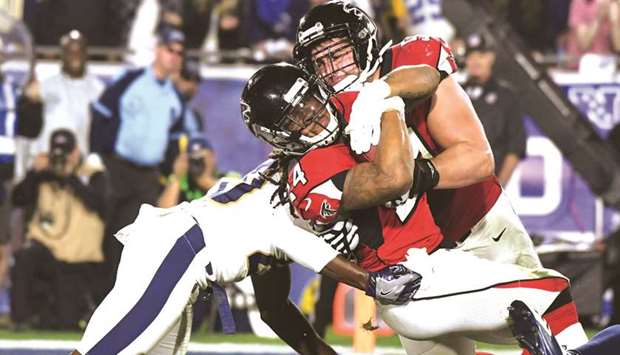 Atlanta Falcons running back Devonta Freeman (left) rushes for a touchdown against Los Angeles Rams free safety Lamarcus Joyner during the NFC Wild Card playoff in Los Angeles. (USA TODAY Sports)