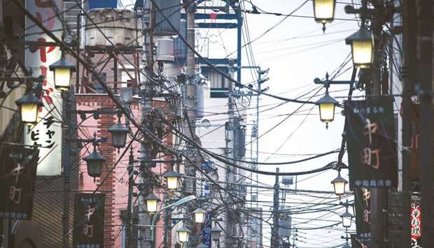 Power and utility cables hang from poles on a street in Hachioji in Tokyo. Royal Dutch Shell has set up a small desk to trade electricity in Japan, where it is in an  u201cexperimentalu201d phase of learning to buy and sell power and identify industrial customers.