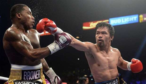 Manny Pacquiao (black trunks) and Adrien Broner (purple/gold trunks) box during a WBA welterweight world title boxing match at MGM Grand Garden Arena.