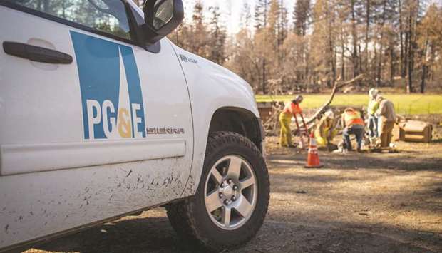 PG&E employees work on gas lines in Paradise, California. PG&E Corp and its Pacific Gas & Electric Co utility filed for Chapter 11 bankruptcy in San Francisco as investigators probe whether its equipment ignited the deadliest fire in state history. The San Francisco-based company listed $51.7bn in total debts and $71.4bn in assets.