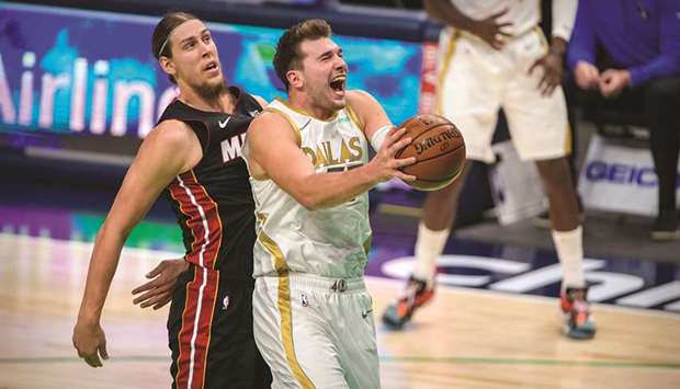 Dallas Mavericks guard Luka Doncic (right) drives to the basket past Miami Heat forward Kelly Olynyk during the second quarter of their NBA game at the American Airlines Center in Dallas, Texas, USA. (USA TODAY Sports)