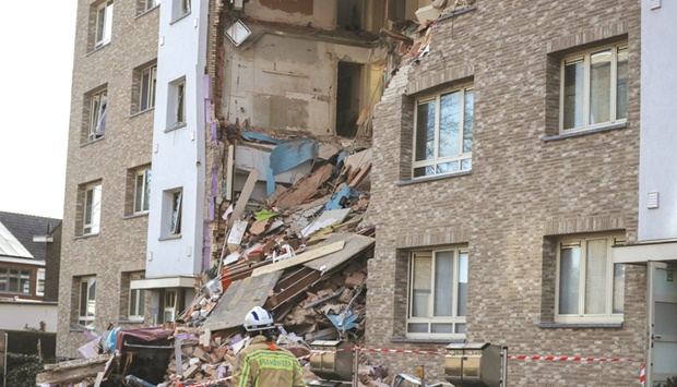 A rescue forces member prepares to inspect the rubble of a building after an explosion in Turnhout, Belgium.