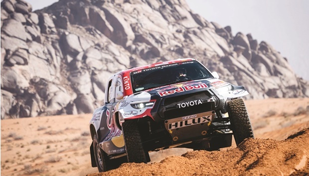 Qataru2019s Nasser al-Attiyah and his French co-driver Mathieu Baumel compete in their Toyota Hilfux T1+ during the opening stage of the Dakar Rally in Hail, Saudi Arabia, yesterday. (AFP)