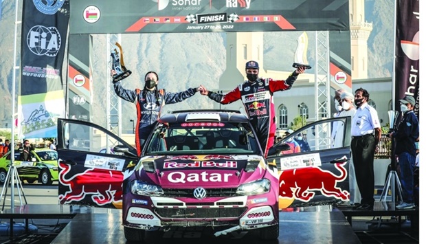 Qataru2019s Nasser Saleh al-Attiyah and his Spanish co-driver Alba Sanchez Gonzalez celebrate after winning the Oman Rally Sohar International in Muscat Saturday