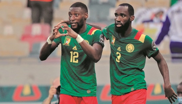 Cameroonu2019s Karl Toko-Ekambi (left) celebrates with teammate Nicolas Moumi Ngamaleu after scoring against Gambia in the Africa Cup of Nations quarter-finals in Douala, Cameroon, yesterday. (Reuters)