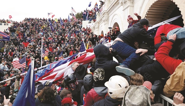 Pro-Trump protesters are seen storming the US Capitol during clashes with police during a rally on January 6 last year.