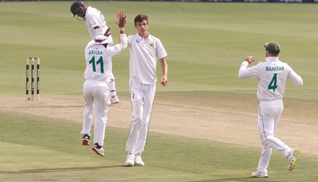 South Africau2019s Marco Jansen celebrates with Temba Bavuma (left) after taking the wicket of Indiau2019s Rishabh Pant on the first day of the second Test in Johannesburg yesterday. (Reuters)