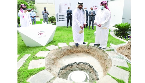 QIC Group CEO Salem al-Mannai and another official burying the time capsule