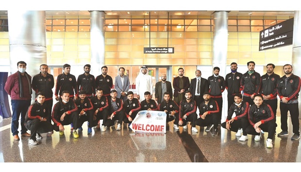 Afghanistan players and officials pose after their arrival in Doha yesterday.