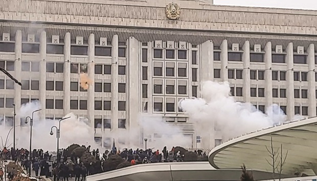 Image grab shows protesters near an administrative building during a rally over a hike in energy prices in Almaty yesterday.