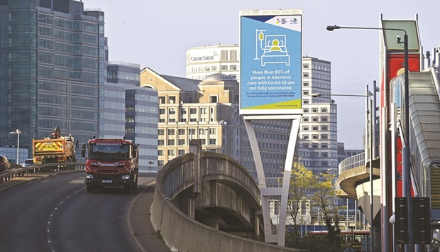 Signs promote the governmentu2019s Covid-19 vaccine programme and alert passersby, near Canary Wharf in the Tower Hamlets district of east London.