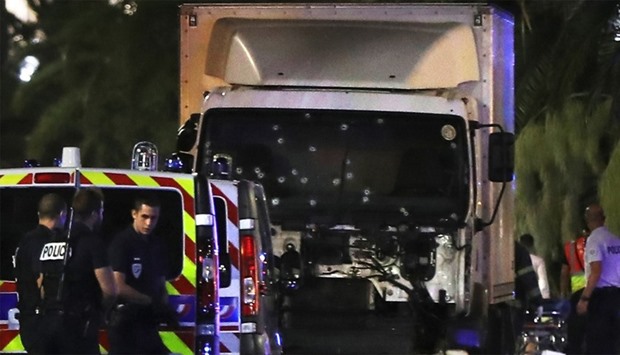 July 14, 2016 shows police officers standing near the truck, with its windscreen riddled with bullet