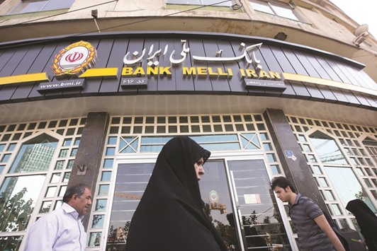 Pedestrians pass a Bank Melli Iran branch in Tehran (file). The gradual opening of Iranu2019s economy to the world after the lifting of Western sanctions will not only shake crude oil markets, but expectedly also the Islamic finance industry since Iran is one of the largest players in terms of assets in Shariah-compliant banking.