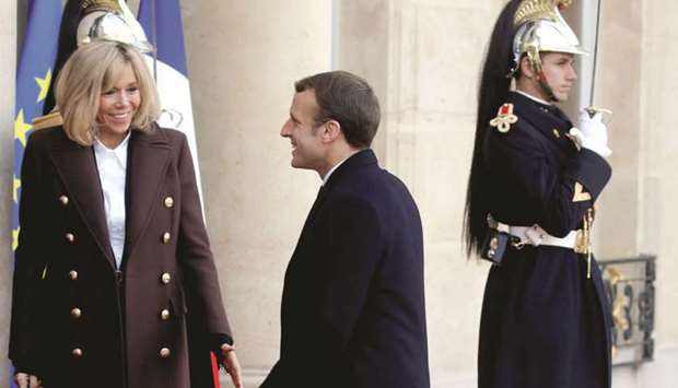 This picture taken on December 12 shows Macron and his wife Brigitte before welcoming guests for lunch at the Elysee Palace as part of the One Planet Summit in Paris.