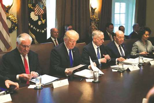 US President Donald Trump, flanked by Secretary of State Rex Tillerson, Defence Secretary James Mattis, Commerce Secretary Wilbur Ross, and Transportation Secretary Elaine Chao, holds a cabinet meeting at the White House in Washington. Senate Republicans passed the most extensive rewrite of the US tax code in more than 30 years, a bill that delivers a deep, permanent tax cut for corporates and shorter-term relief for individuals.