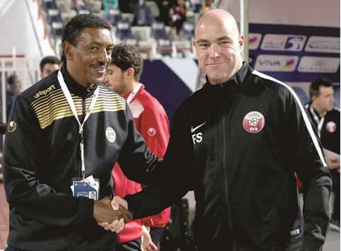 Qataru2019s Spanish coach Felix Sanchez (R) shakes hands with Yemenu2019s Ethiopian coach Abraham Mebratu.