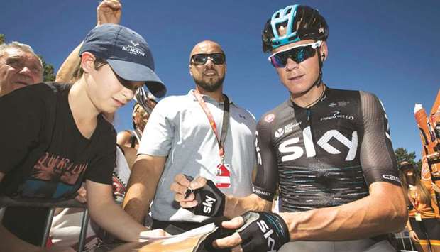 In this August 21, 2017, picture, Skyu2019s Chris Froome signs autographs prior to the start of the third stage of the 72nd edition of Vuelta a Espana in Prades, France.  Froome has returned an adverse analytical finding for asthma medication salbutamol.