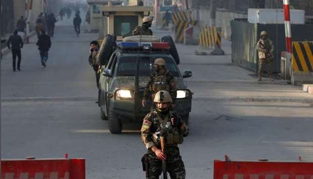 Afghan security forces keep watch at a check point close to the compound of Afghanistan's national intelligence agency in Kabul, Afghanistan