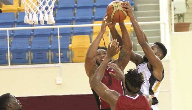 Al Rayyan (in red) and Al Sadd (in white) in action during their Qatar Basketball League match at Al Gharafa Sports Club yesterday. PICTURE: Othman Khalid