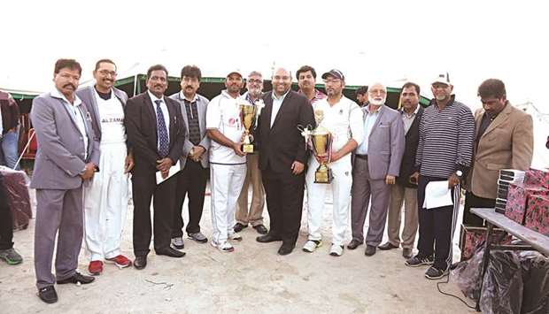 QVC captain Kamran and AL Zaman Exchange skipper Shafi pose with chief guest Sajjad Ahmed Khan